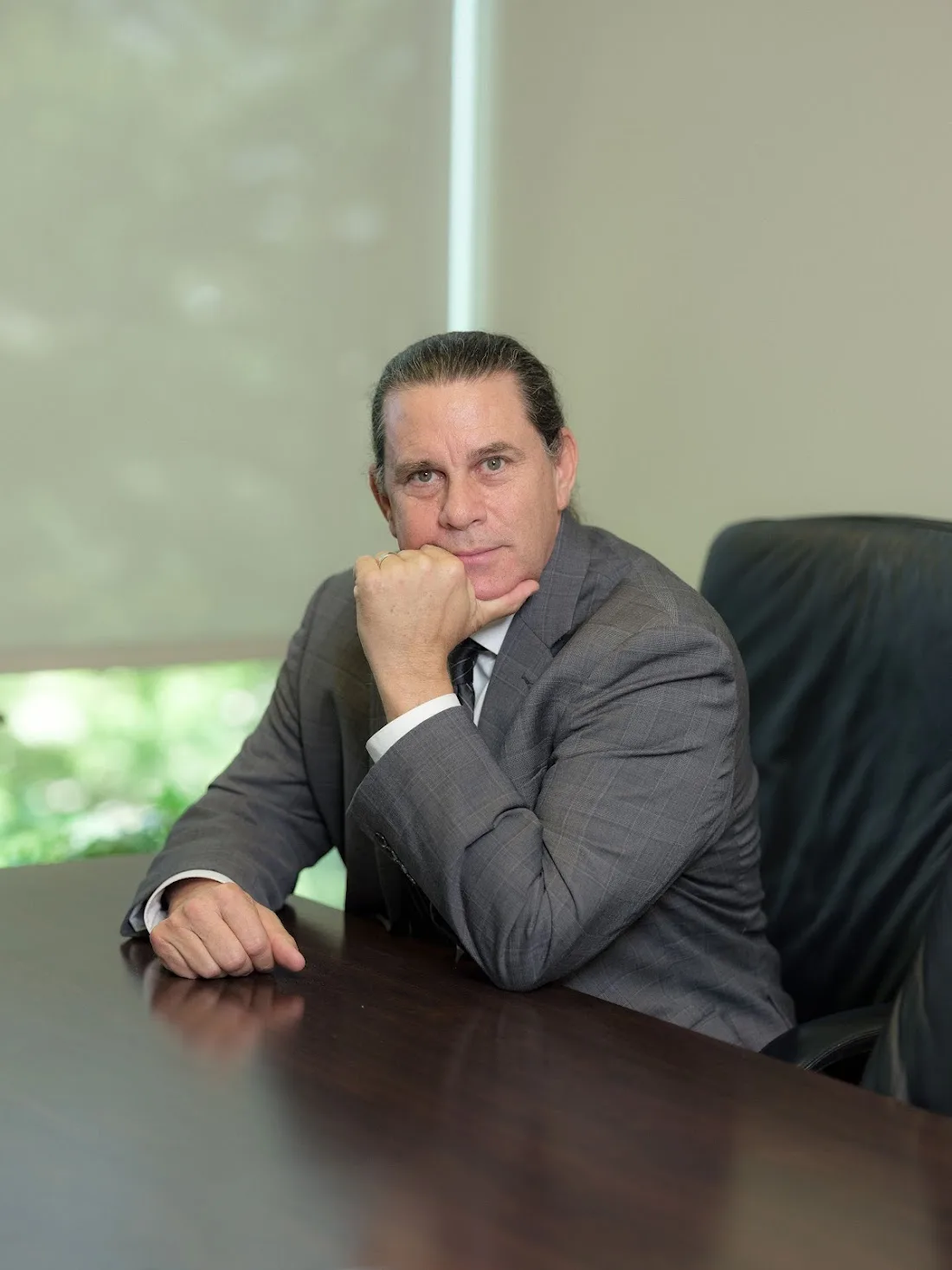 Kent Starr at his office desk, hand to chin in thoughtful posture.